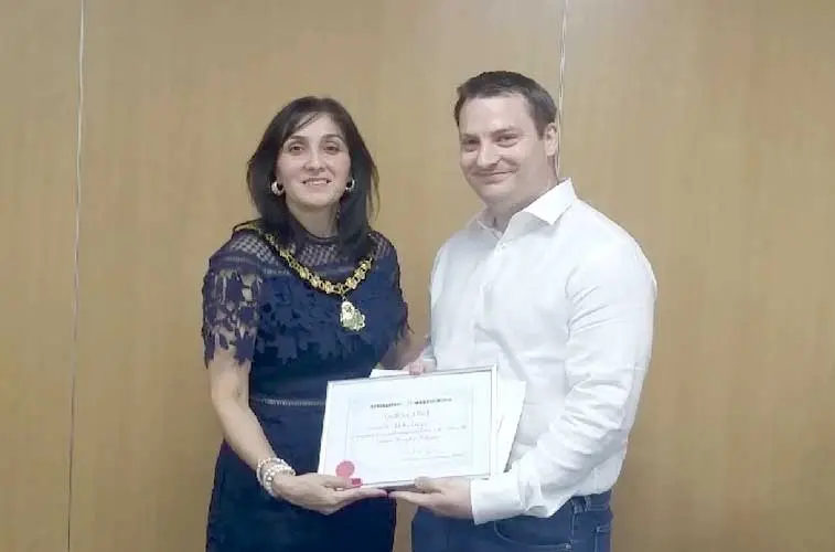 Deputy Mayor of Hillingdon presenting Blake Guyan the award